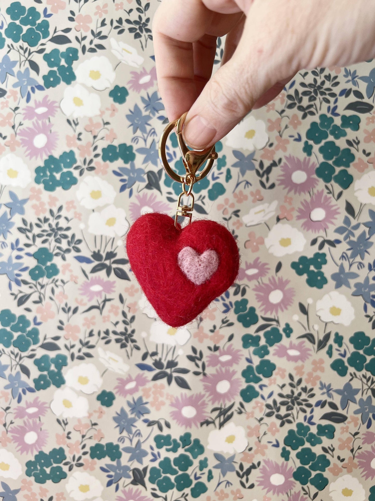 Red heart-shaped keychain with a pink heart 