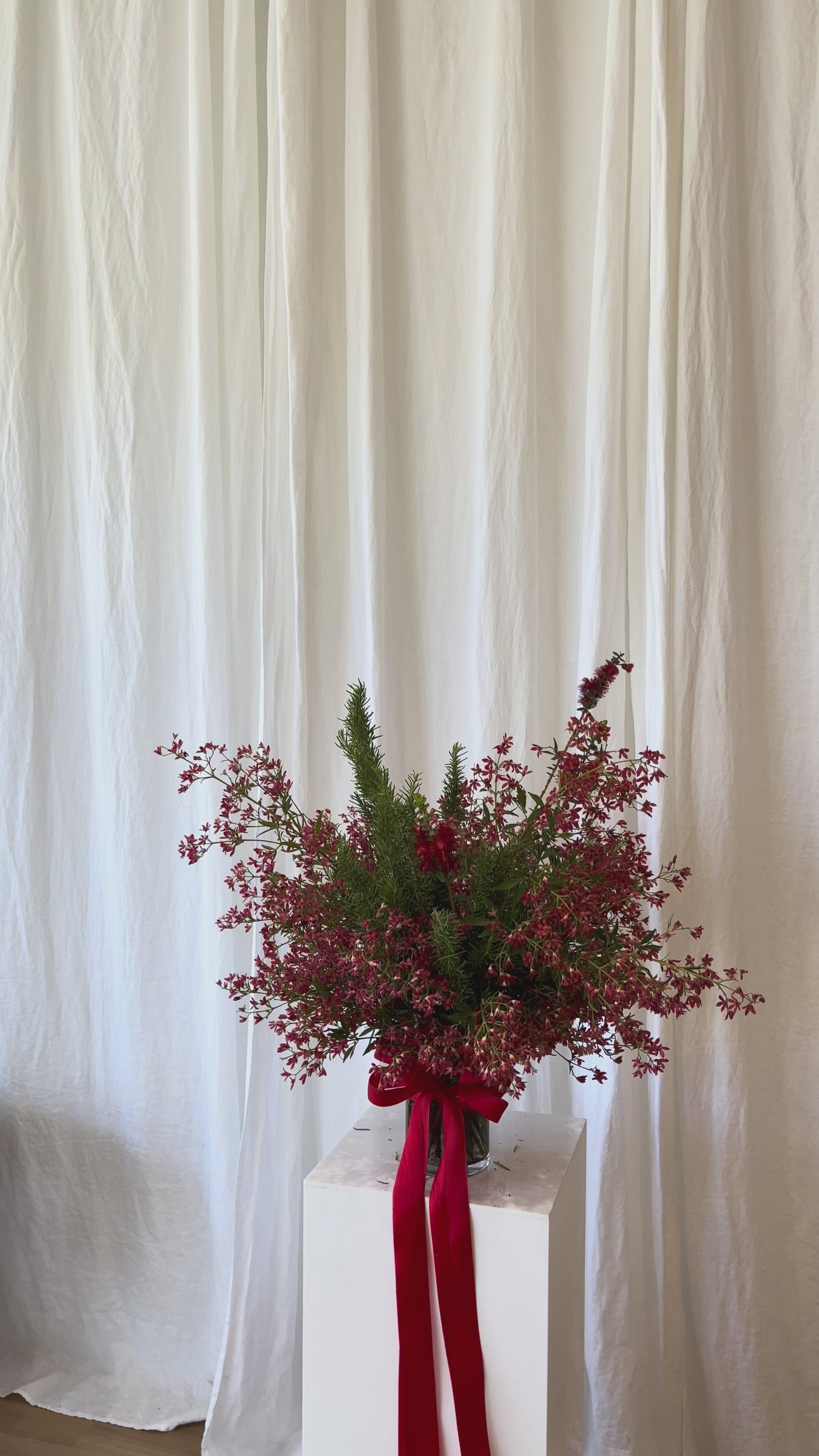 Festive red Christmas flower vase with seasonal blooms